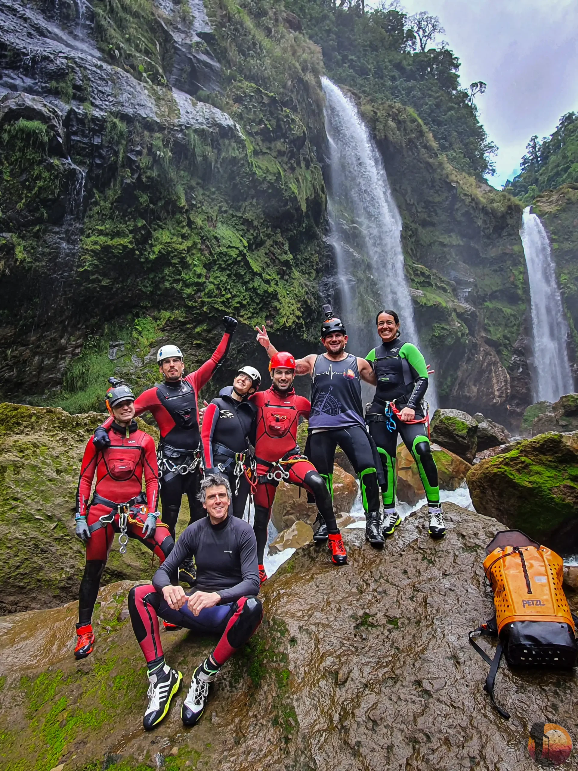A group crossing a river on a guided hike